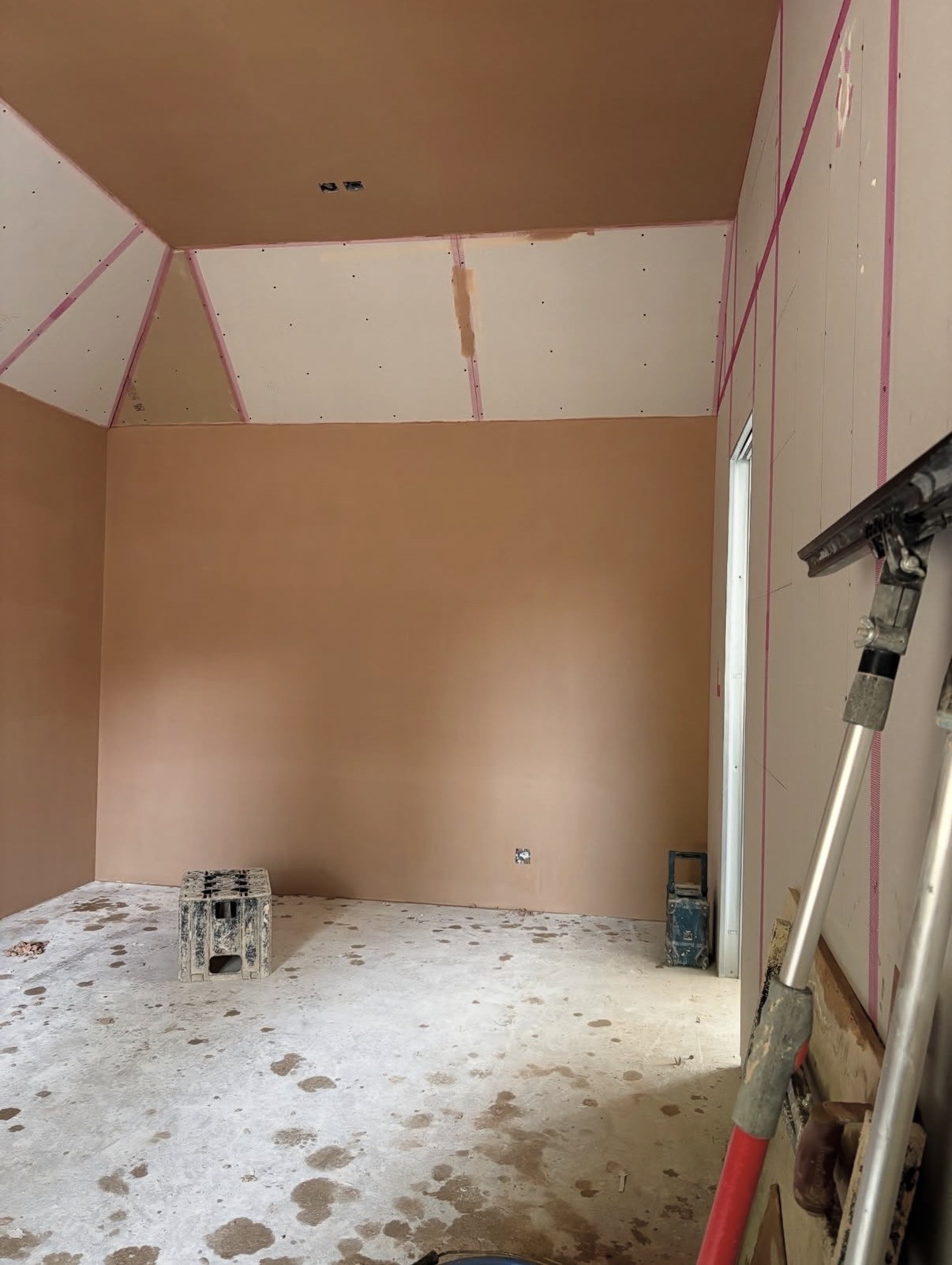 Interior room freshly plastered with pink finish plaster on walls and ceiling